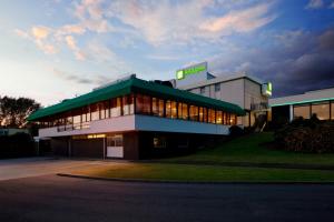 a building with a sign on top of it at Holiday Inn Stoke on Trent M6 Jct15 by IHG in Stoke on Trent