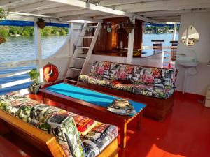 a boat with couches and a table on a boat at Selvagem Tours in Alter do Chao