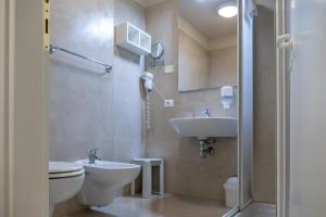 a bathroom with a toilet and a sink at Hotel Venezia Park - ENJOY HOLIDAY in Colà di Lazise