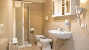 a bathroom with a toilet and a sink and a shower at Hotel Venezia Park - ENJOY HOLIDAY in Colà di Lazise +54 photos