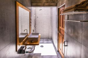 a bathroom with two sinks and a shower at Endheri Sunset Dhangethi in Dhangethi