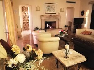 a living room with a couch and a fireplace at Villa La Valiana - Full Estate in Montepulciano - HEATED POOL in Valiano