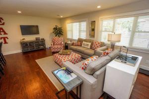 a living room with a couch and a tv at Beautiful, Modern Getaway in Historic Downtown Beaufort in Beaufort