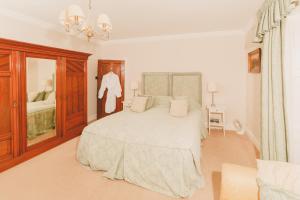 a white bedroom with a large bed and a window at Riding Farm in Gateshead