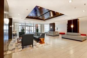 a lobby with couches and chairs in a building at Holiday Inn - Ottawa Dwtn - Parliament Hill, an IHG Hotel in Ottawa