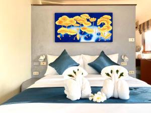 a bedroom with a bed with white towels on it at Green​ house​ Samui in Bophut