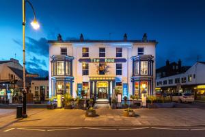 a large white building on a city street at night at The Bold Hotel; BW Signature Collection in Southport