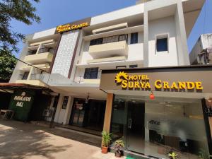 a large white building with a hotel supreme grande at Hotel Surya Grande in Kudal