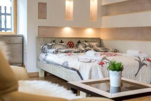 a room with two beds and a coffee table at Willa Czajka - Widokowe Apartamenty in Zakopane