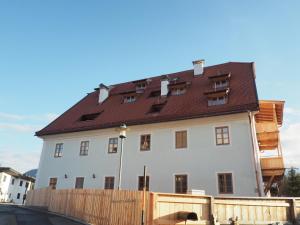 a large white building with a brown roof at Flösserhaus - Kirchbichl Top 1 in Kirchbichl