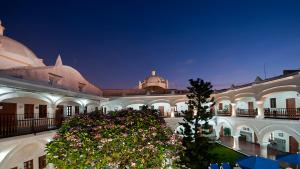 a large building with a tree in front of it at Holiday Inn Express Veracruz Centro Historico by IHG in Veracruz