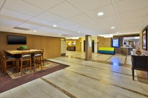 a dining room with a table and chairs in a lobby at Holiday Inn Gaithersburg, an IHG Hotel in Gaithersburg