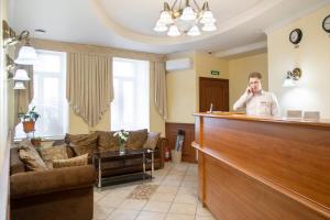 a man talking on a cell phone in a waiting room at Sokroma Nevsky Fort in Saint Petersburg