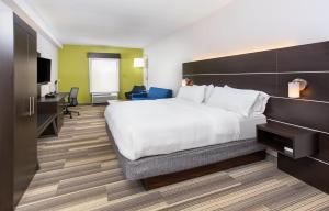 a hotel room with a large bed and a desk at Holiday Inn Express & Suites Morristown, an IHG Hotel in Morristown