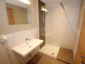 a bathroom with a sink and a shower at Apart Gletscherblick in Kaunertal