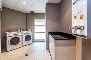 a laundry room with a washer and dryer at Holiday Inn Laval Montreal, an IHG Hotel in Laval
