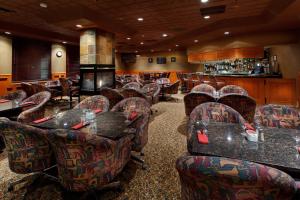 um restaurante com cadeiras e mesas e uma lareira em Holiday Inn Hinton, an IHG Hotel em Hinton