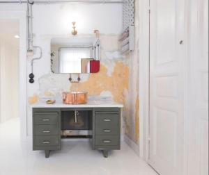 a bathroom with a sink and a mirror at Trilogy Experimental in Thessaloniki