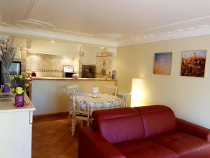 a living room with a red couch and a table at Villa Lavanda in Trans-en-Provence