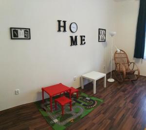 a room with two red tables on a green rug at Jezerka Apartments in Prague