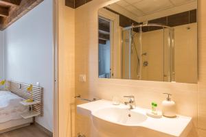a bathroom with a sink and a mirror at Torre della Loggia - Dimora Storica - Ortona in Ortona