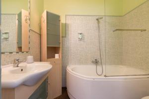 a bathroom with a tub and a sink and a shower at B&B Teatro Bellini in Catania