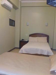 Cama o camas de una habitación en Hostal Cristhian Inn
