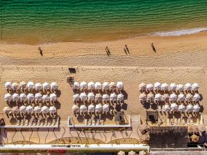 an overhead view of a beach with chairs and the ocean at Casa Dorada Los Cabos Resort & Spa in Cabo San Lucas