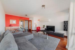 a living room with a couch and a table at Funchal Lounge Apartment by Amazing Madeira in Funchal