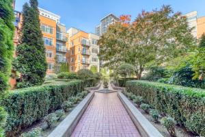 a garden with a brick walkway and a fountain at Belltown Court North in Seattle