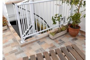 a stairway with a wooden bench and potted plants at Casa Cabanyal in Valencia