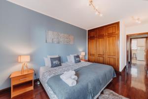 a bedroom with a bed with two white towels on it at Funchal Lounge Apartment by Amazing Madeira in Funchal +18 photos