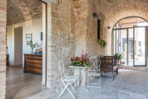 a patio with a table and chairs in it at Torre della Loggia - Dimora Storica - Ortona in Ortona