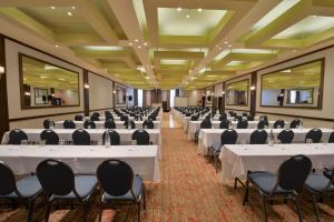 a banquet hall with white tables and chairs at Holiday Inn Montreal Centre Ville Downtown, an IHG Hotel in Montreal