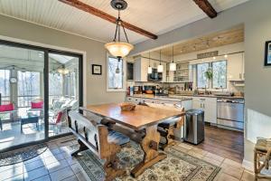 a large kitchen with a wooden table and chairs at Peaceful Goshen Cottage with Screened Porch and Views! in Goshen