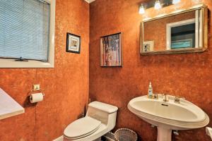a bathroom with a sink and a toilet and a mirror at Peaceful Goshen Cottage with Screened Porch and Views! in Goshen +16 photos
