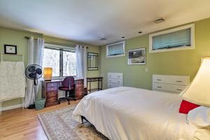 a bedroom with a bed and a desk and a window at Peaceful Goshen Cottage with Screened Porch and Views! in Goshen