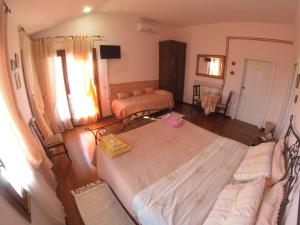 a bedroom with two beds and a living room at Guest house Villa di Judighes in Cerveteri