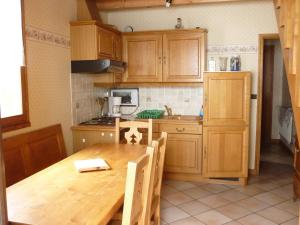 a kitchen with wooden cabinets and a wooden table at Chalet Analma in Planay