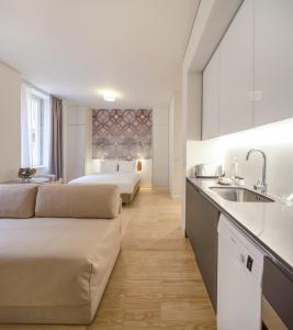 a hotel room with two beds and a sink at LSA Santos by Numa in Lisbon +60 photos