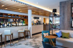 a bar in a hotel with chairs and a counter at Holiday Inn Salisbury - Stonehenge, an IHG Hotel in Salisbury