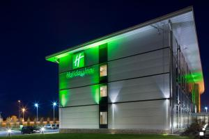 a building with a green sign on the side of it at Holiday Inn Salisbury - Stonehenge, an IHG Hotel in Salisbury