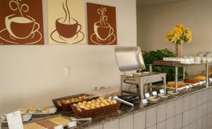a kitchen with a counter with aasteryasteryasteryasteryasteryasteryasteryasteryastery at Iracema Mar Hotel in Fortaleza +41 photos