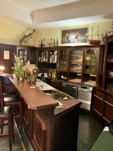 a large kitchen with wooden cabinets and a counter top at Bluhm's Hotel & Restaurant am Markt in Kyritz