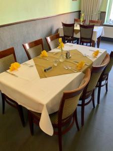Bluhm's Hotel & Restaurant am Markt في كيريتز: طاولة طعام عليها مناديل صفراء
