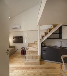 a staircase in a room with a kitchen and a living room at LSA Santos by Numa in Lisbon