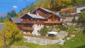 a large building with an umbrella in front of it at Chalet les marmottes in Planay