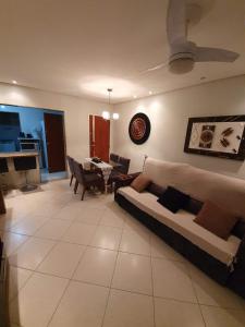 a living room with a couch and a table at Apartamento dois quartos perto da praia em Jardim Camburi in Vitória