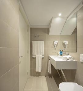 a bathroom with a sink, toilet and bathtub at Lisbon Serviced Apartments - Santos in Lisbon