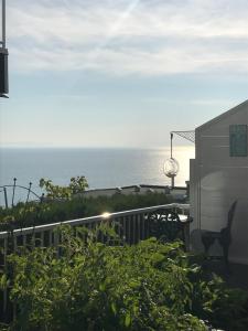 a view of the ocean from the balcony of a house at Donna's Bed & Breakfast in White Rock